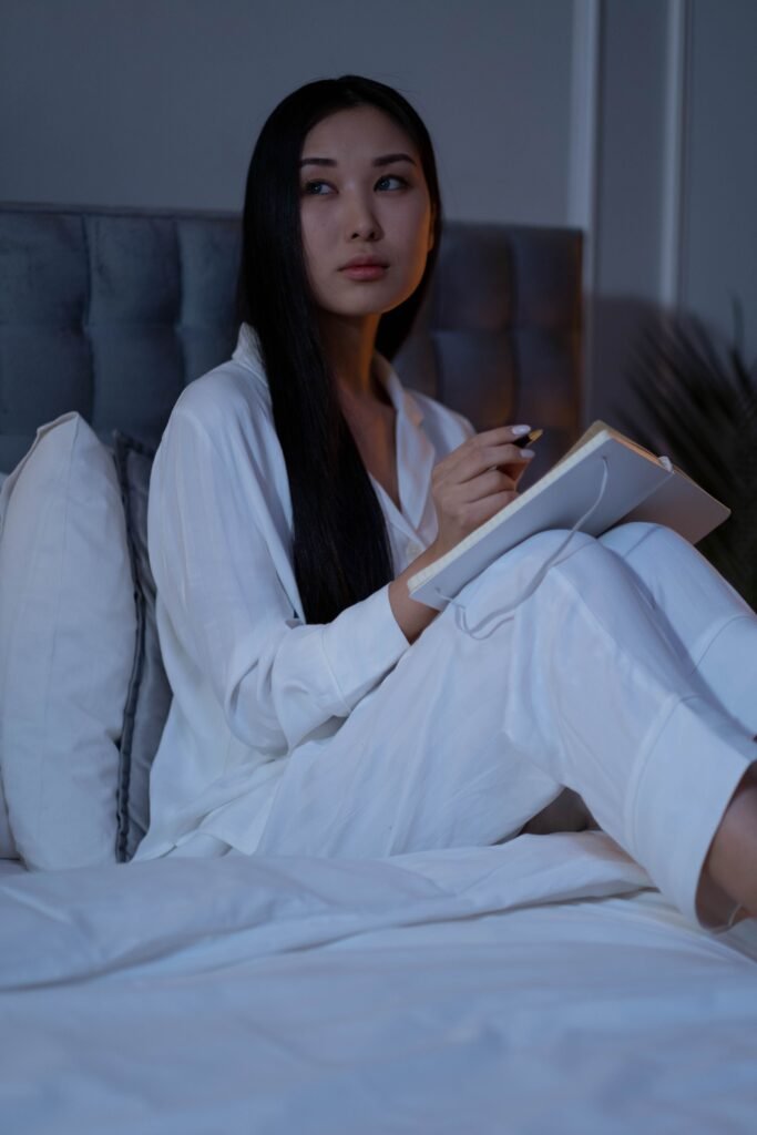 A woman is working calmly with a planner and tea instead of multitasking.